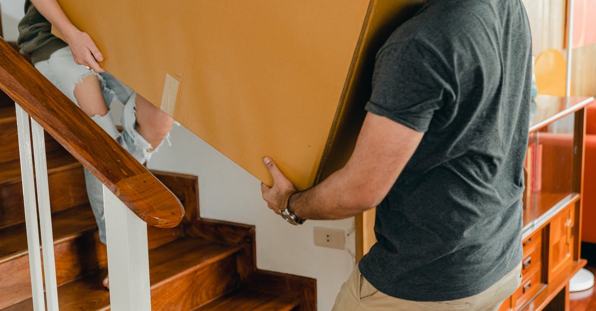 Airport security: what if I carry an item with traces of explosive? - Couple carrying personal items box down stairs Airport security: what if I carry an item with traces of explosive? - Couple carrying personal items box down stairs