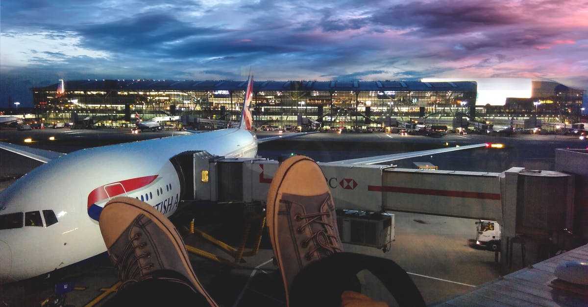 Airside arrivals area at Heathrow T3 - Person Wearing Gray Low-top Shoes