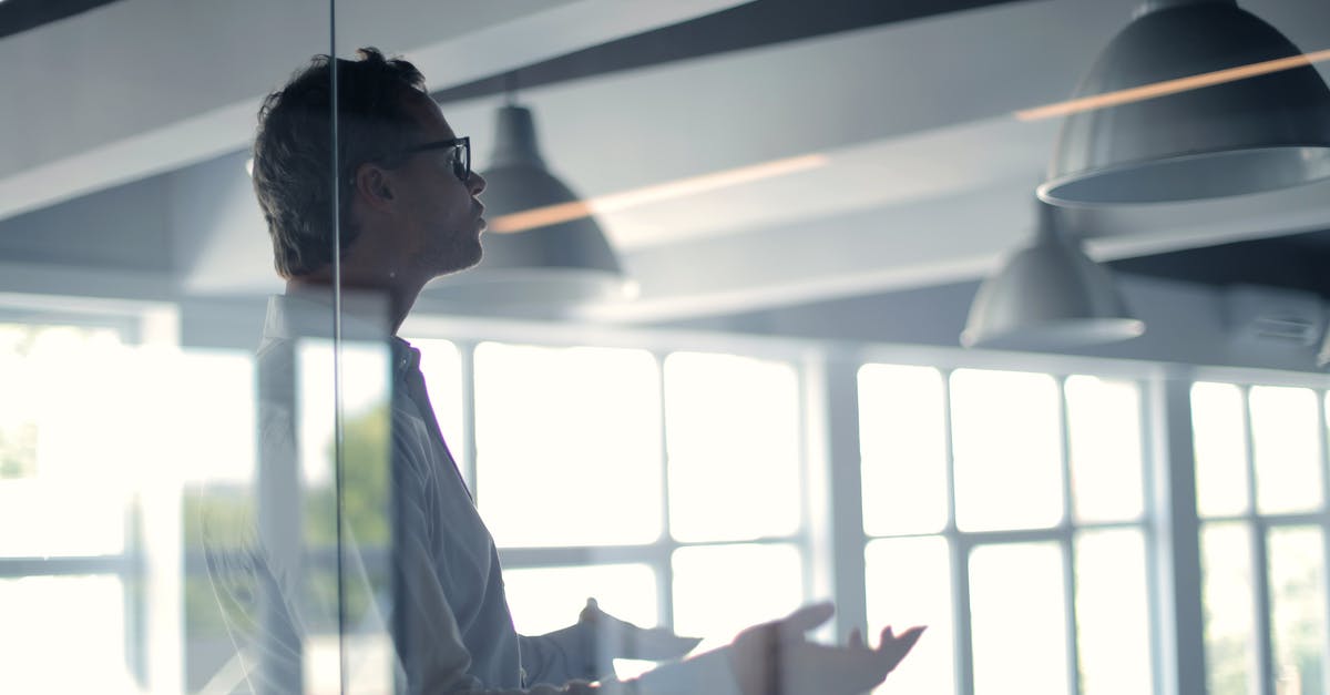 Air-side walk-through light boxes. What are they? - Male employer gesticulating and explaining idea in light office