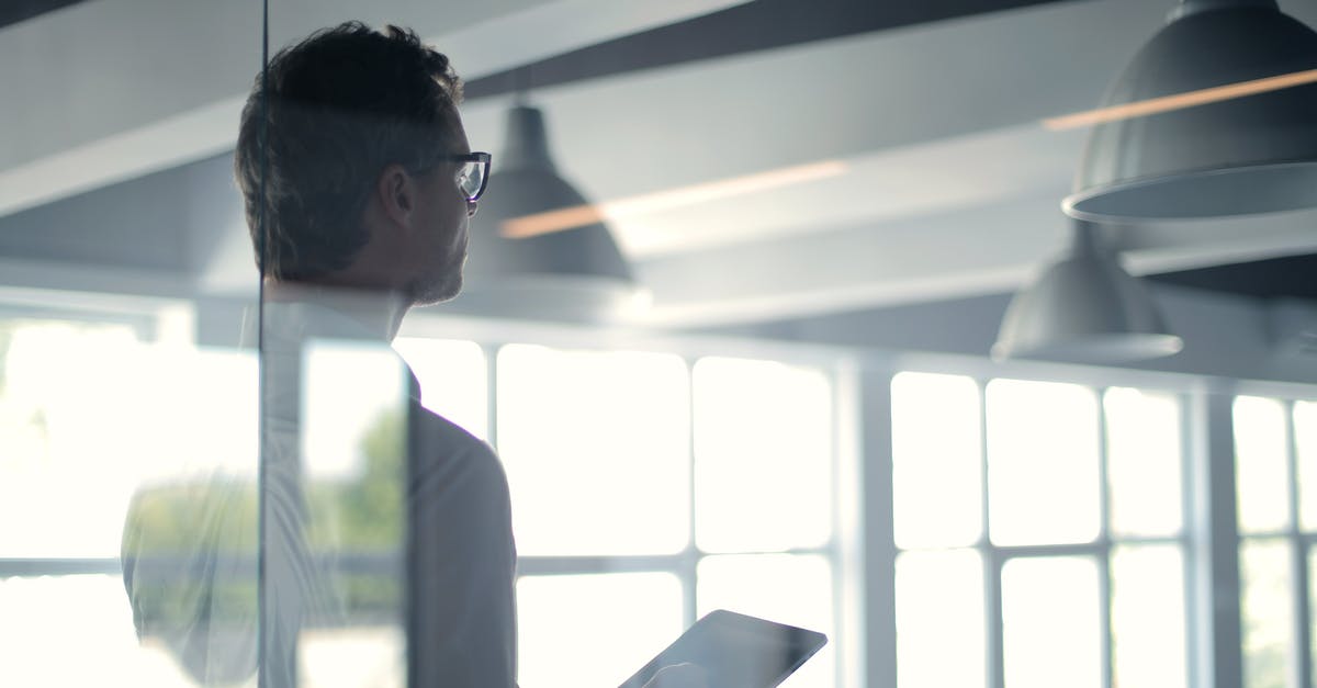 Air-side walk-through light boxes. What are they? - Formal man with tablet giving presentation in office