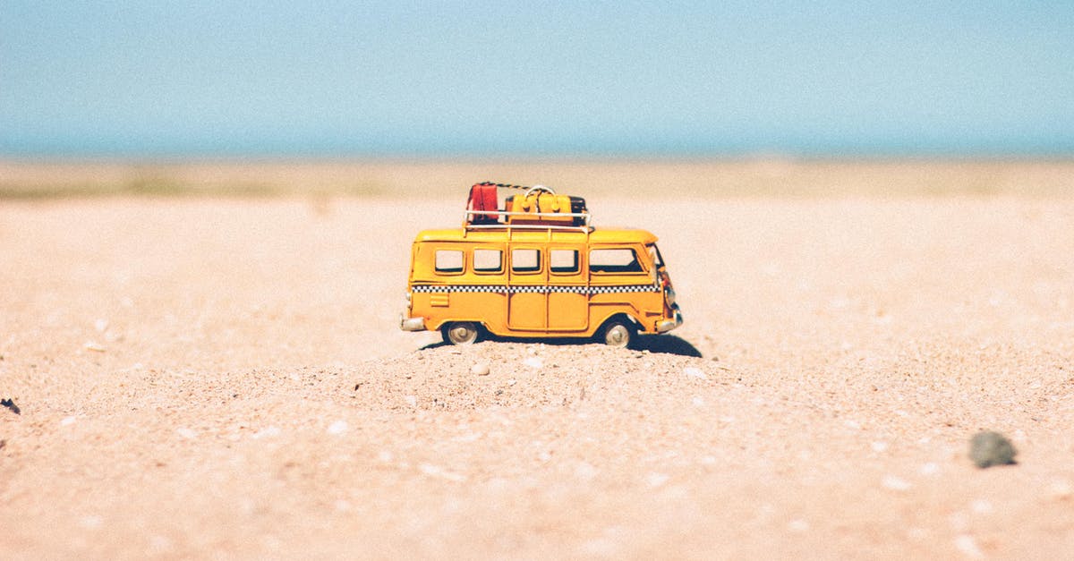 Alaska, from Anchorage to Fairbank, car/hotel vs MotorHome - Yellow Die-cast Miniature Van on Brown Sand