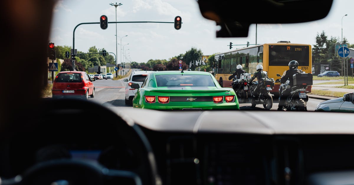 Albania traffic requirements - Green and White Police Car on Road during Night Time