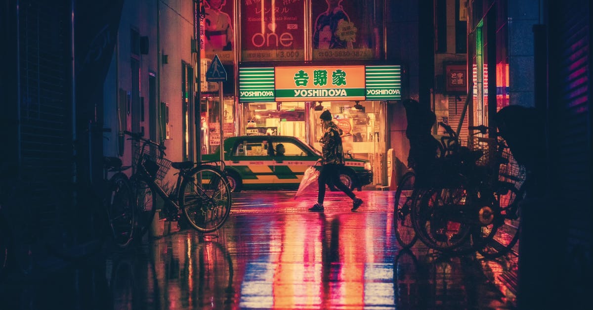 Alternatives to taxis in Japan - Side View of  Woman in Illuminated City at Night