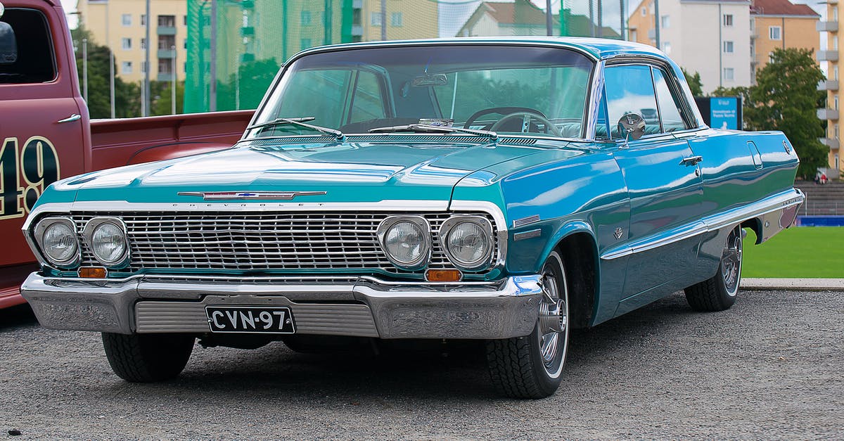 Am I covered to drive my parent's car while visiting? - Classic Blue Coupe Parked Besides Red Pickup Truck