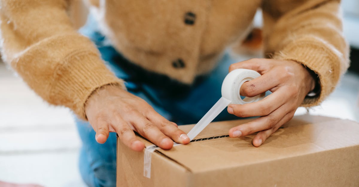 Am I expected to tip for room service on top of the Service and delivery fee? - Crop unrecognizable woman sealing carton parcel with tape