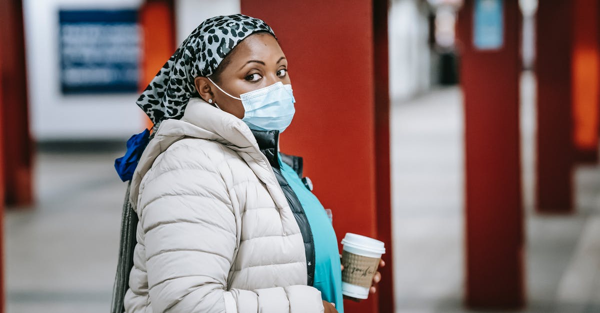 Am I expected to tip wait staff in Europe? - Black nurse in outerwear standing on metro platform