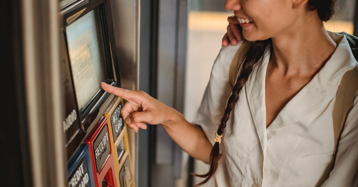 Am I required to buy a train ticket in order to use the locker facility at Zurich station? - Crop smiling Asian female in white shirt using ticket vending machine with touch screen in underground Am I required to buy a train ticket in order to use the locker facility at Zurich station? - Crop smiling Asian female in white shirt using ticket vending machine with touch screen in underground