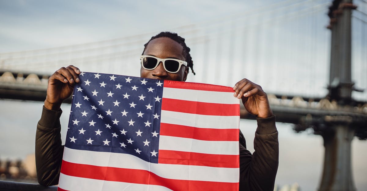 American citizen traveling back to US with foreign friend - Friendly man with US flag kerchief in hands