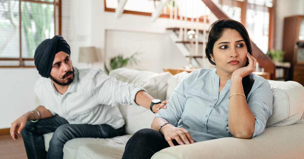 American ID requirements for indian domestic flights - Thoughtful man talking to upset woman on couch