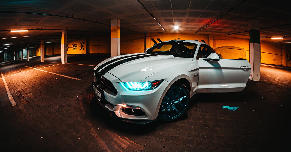 American renting car in UK - Parked White Coupe Inside Parking Lot