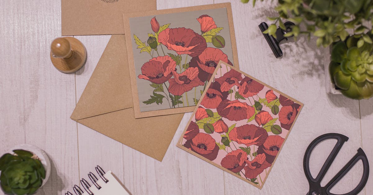 Amount of stamps for sending postcards from India - Layout of fresh succulents and creative handmade postcards with flowers pictures on white wooden table composed with scissors and notepad