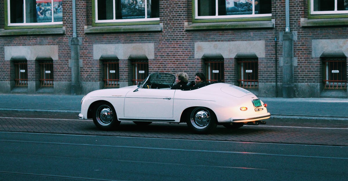 Amsterdam to Berlin - Hire Car - Two People Riding White Classic Convertible Car