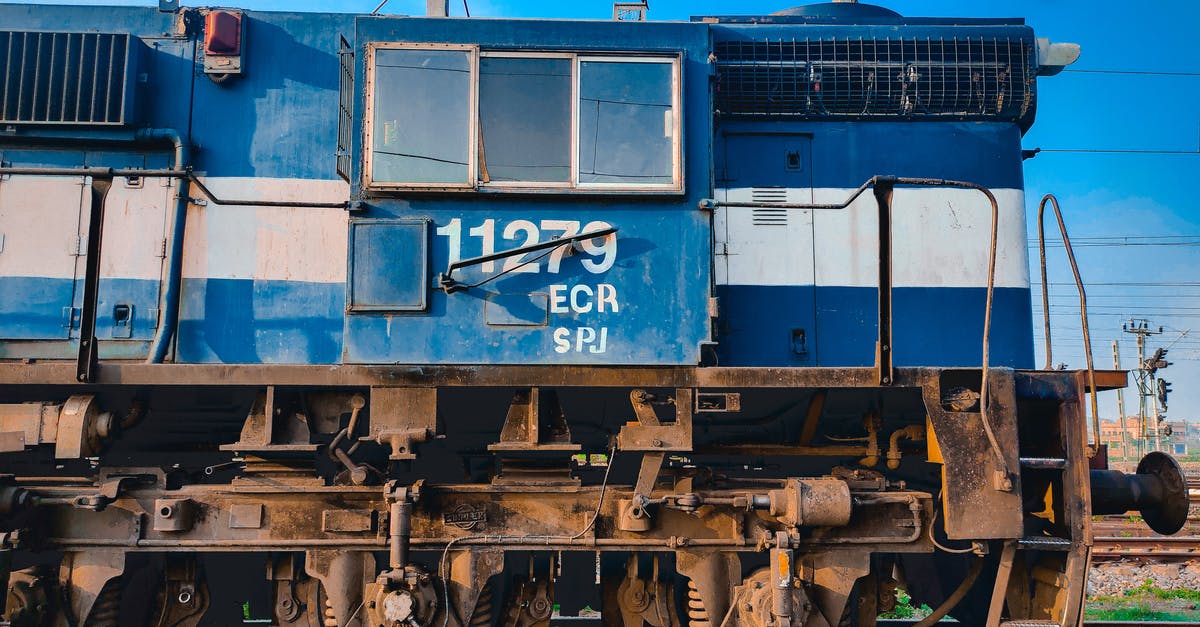 Amsterdam To Rotterdam by train - Blue and Brown Train on Rail Tracks