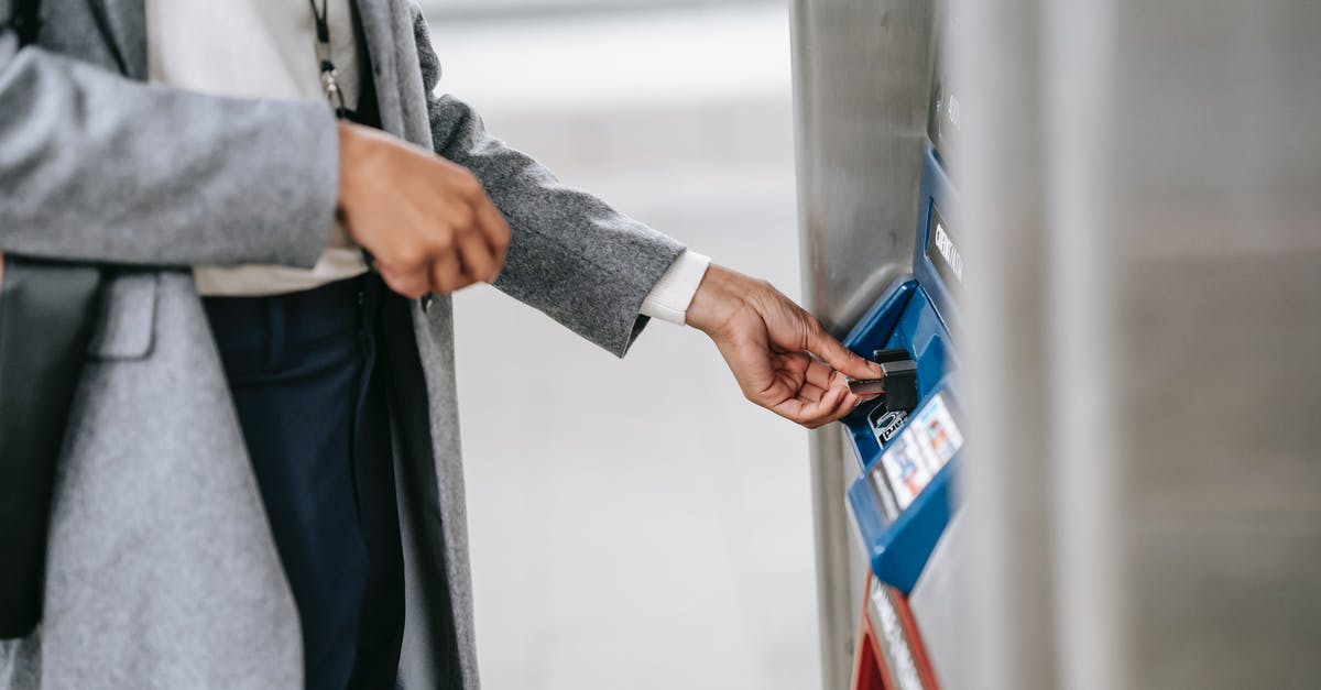 Amtrak - Why can she not buy two tickets for herself? - Faceless woman buying metro ticket via electronic machine