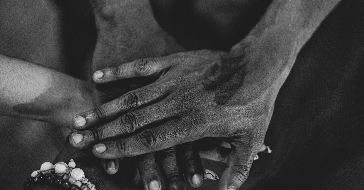 Amtrak Code-share with United Airlines [closed] - Grayscale Photo of People's Hands Stacked Together