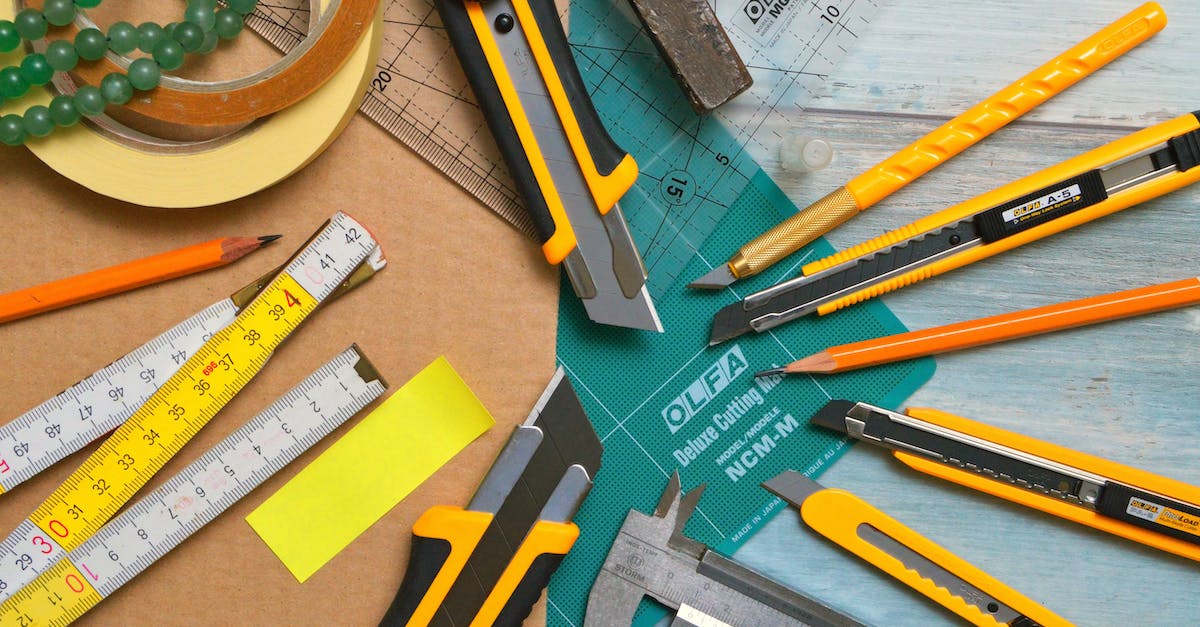 Amtrak "large sharp objects" restriction: Are small knives included? - Assorted-type-and-size Utility Cutters on Clear and Green Olfa Measuring Tool Near Adhesive Tape Rolls