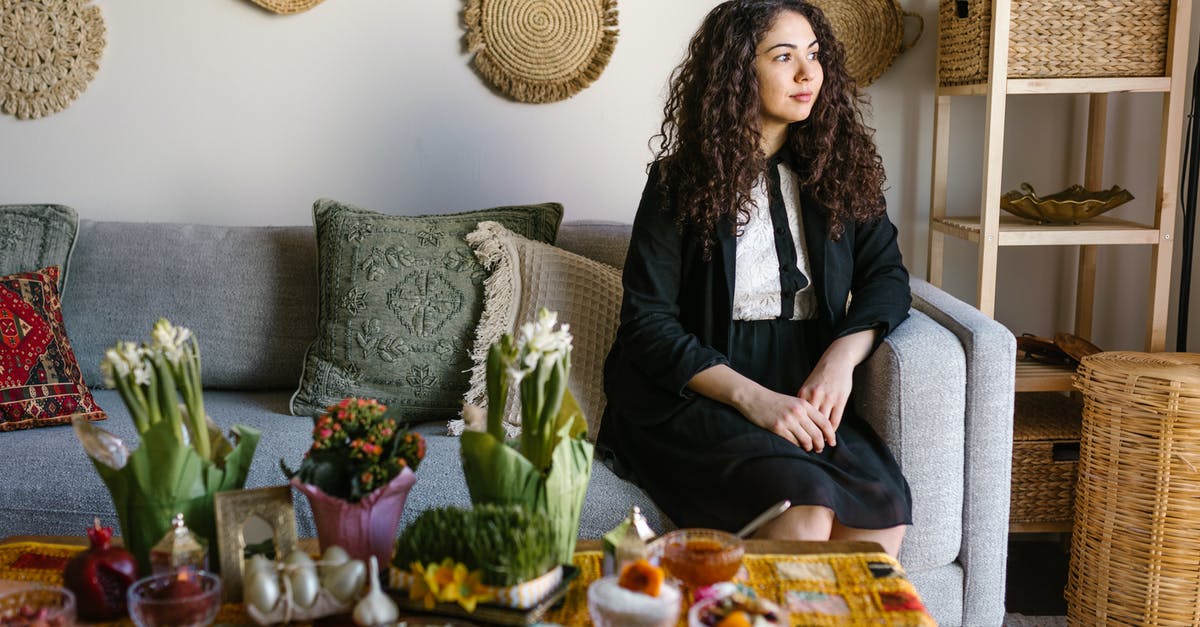 An authentic way to celebrate Novruz in Azerbaijan - Woman Sitting On A Couch Beside Table With Traditional Food