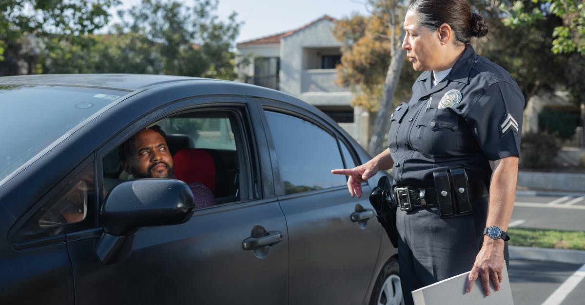 Any trouble at Florida customs for not paying a California speeding ticket from 5 years ago? - Policewoman Talking to a Man Riding in a Car Any trouble at Florida customs for not paying a California speeding ticket from 5 years ago? - Policewoman Talking to a Man Riding in a Car