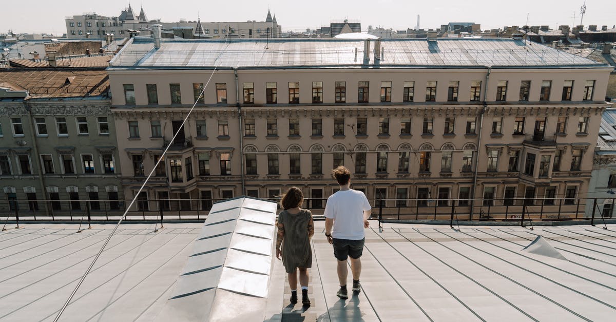 Any walking tours (in English) in Cologne or nearby? - Man in White T-shirt and Black Shorts Standing on White Tiled Floor