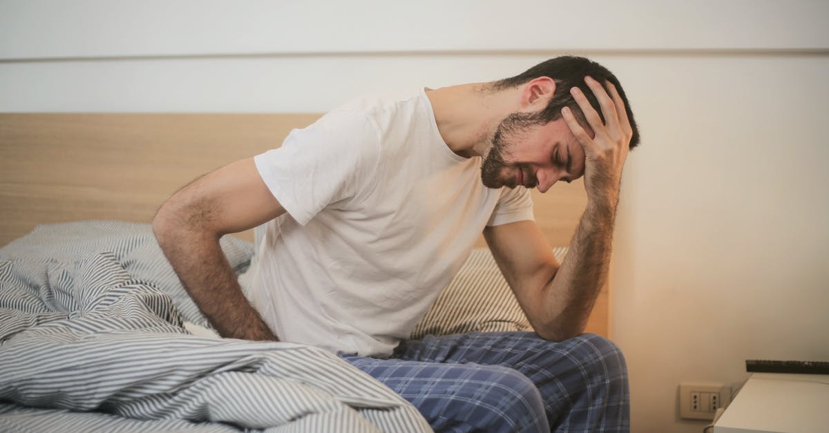 Apartment in Munich [closed] - Young man in sleepwear suffering from headache in morning