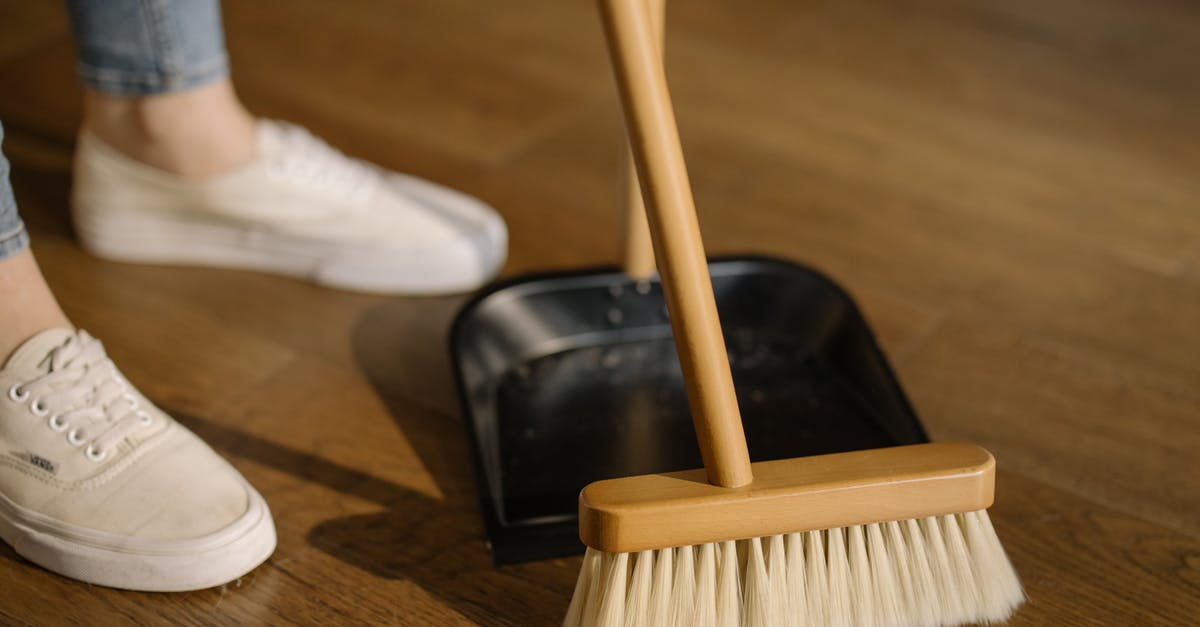 Apartment in Munich [closed] - Person Wearing White Pants and White Socks Standing Beside Brown Broom