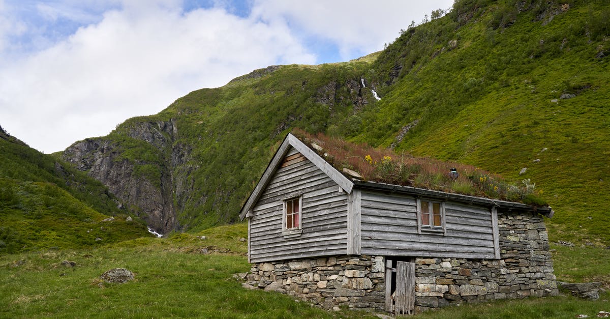 Appeal for refused visa to Norway - Brown Wooden House on Green Grass Field Near Mountain Under White Clouds