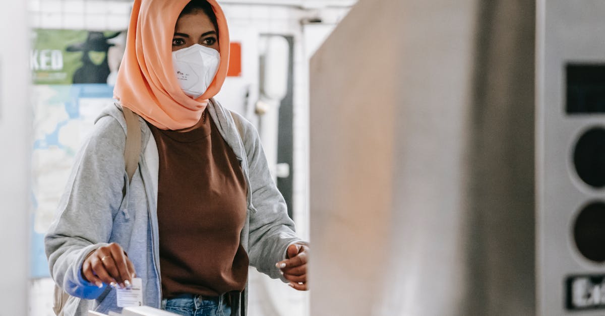 apply for visit visa less than 3 months from Egypt - Muslim female in mask going through turnstile