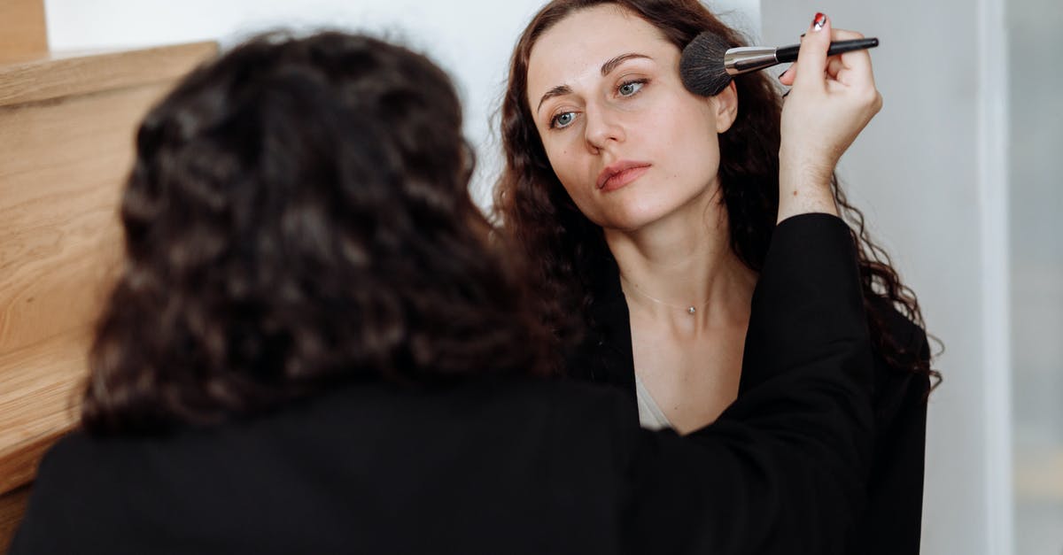 Applying another visa again so soon - Woman in Black Long Sleeve Shirt Holding Makeup Brush