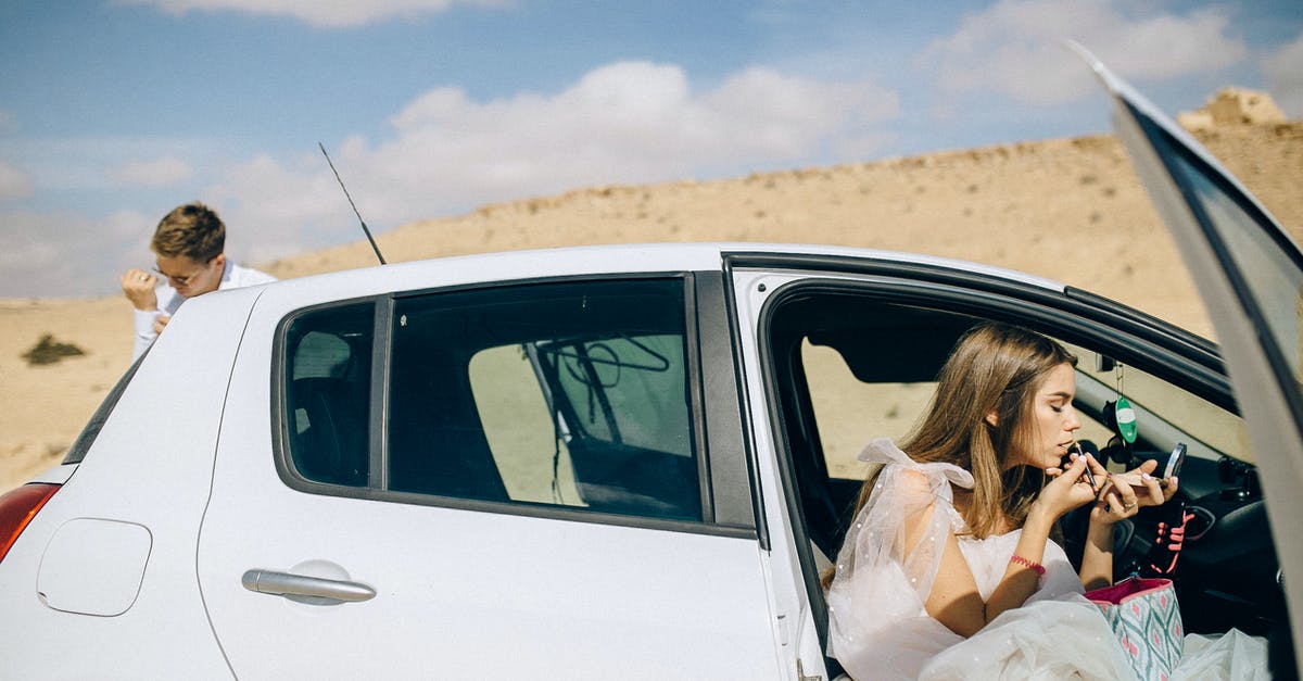 Applying for a B2 while on J1 in the US - Woman in White Dress Sitting on White Car