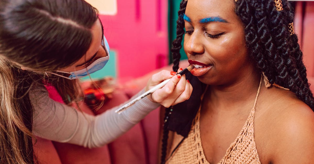 Applying for a Schengen Visa without itinerary - A Woman with Blue Eyebrows Getting Her Makeup Done