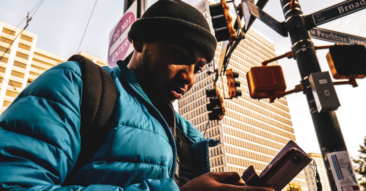 Applying for Canadian Tourist visa using one-way ticket [closed] - Man Wearing Bubble Zip Jacket Using Smartphone