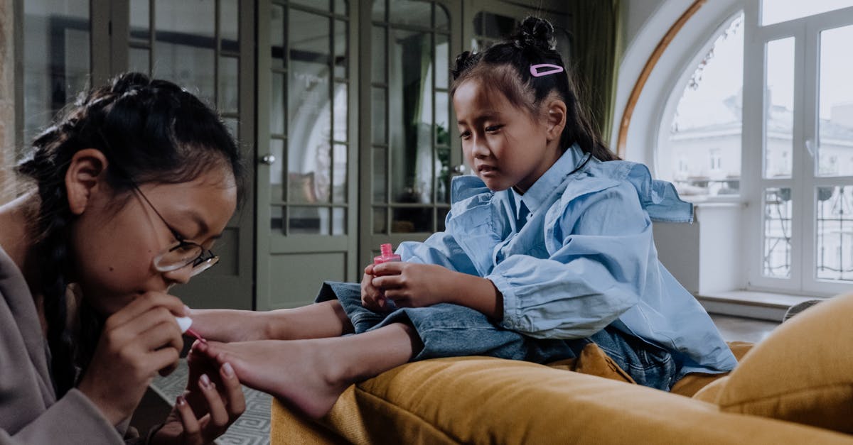 Applying for EEA Family Permit strictly 3 months in advance? - A Young Woman Applying a Nail Polish on Her Sister's Foot