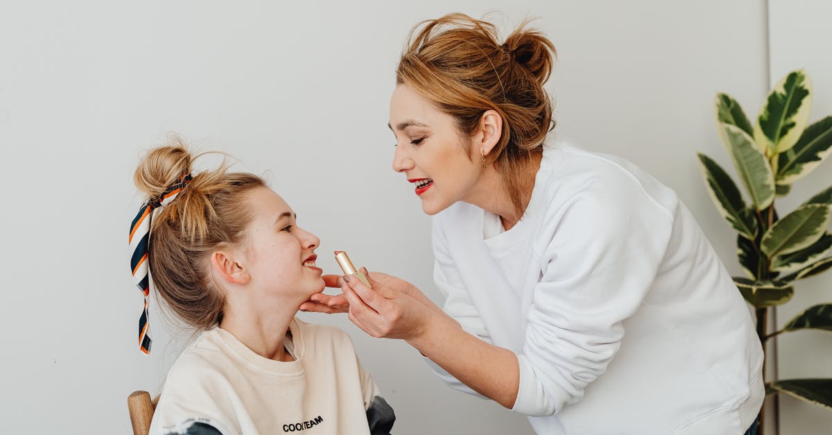 Applying for EEA Family Permit strictly 3 months in advance? - Photograph of a Mother Applying Lipstick on Her Daughter