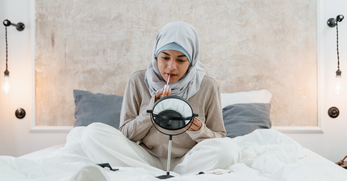 Applying for Schengen Visa in Seattle? - Woman in White Hijab Sitting on White Bed