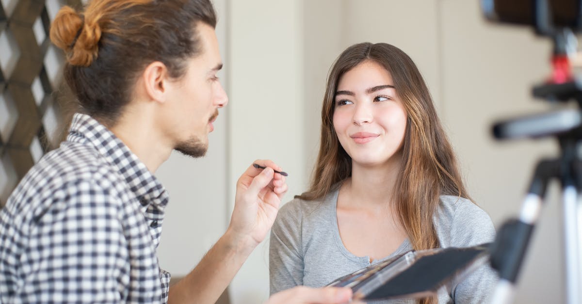 Applying for Schengen Visa in Seattle? - Man in Blue and White Checkered Dress Shirt Holding Woman in Gray Sleeveless Shirt