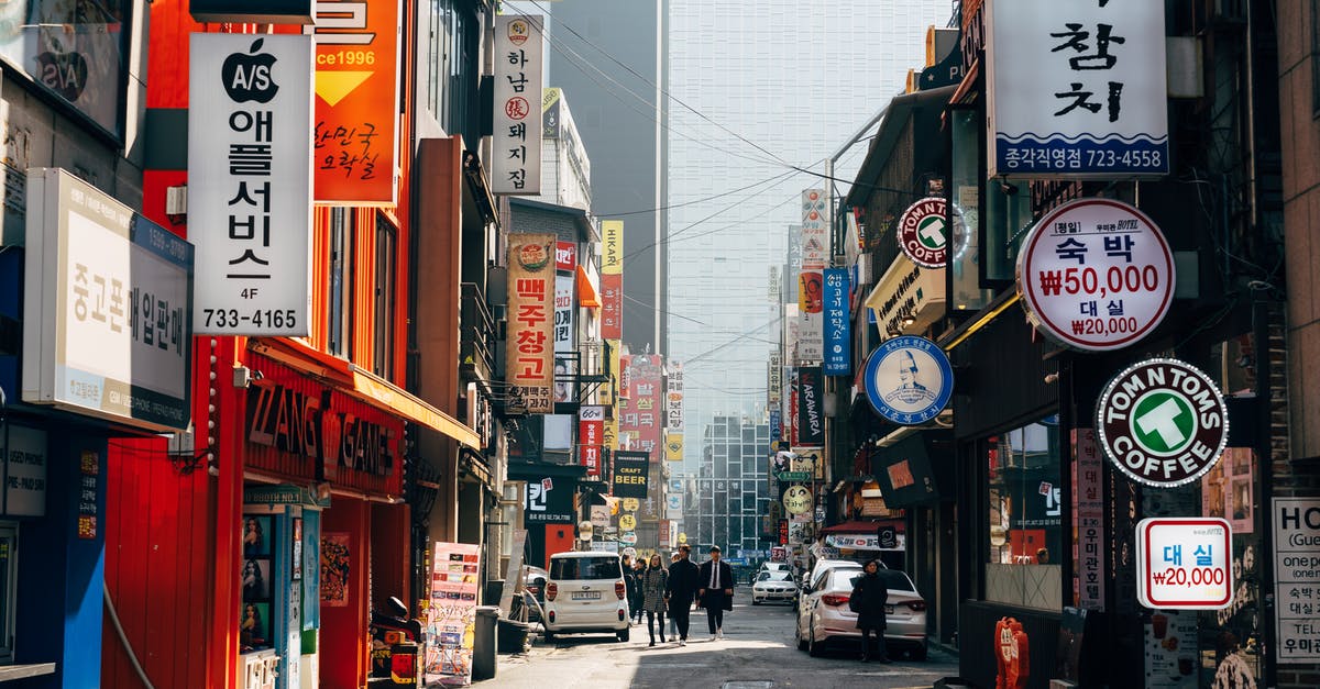 Applying for South Korean tourist visas - People Walking on Sidewalk Near Buildings