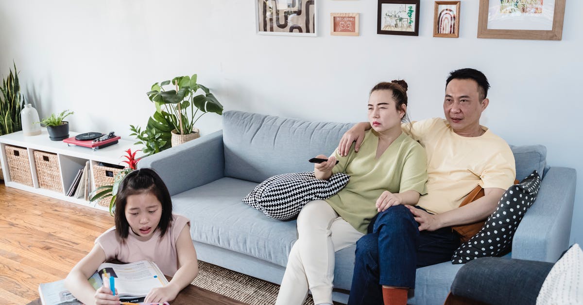 Applying for Two Student Visa [closed] - A Girl Doing her Homework beside her Parents in a Living Room