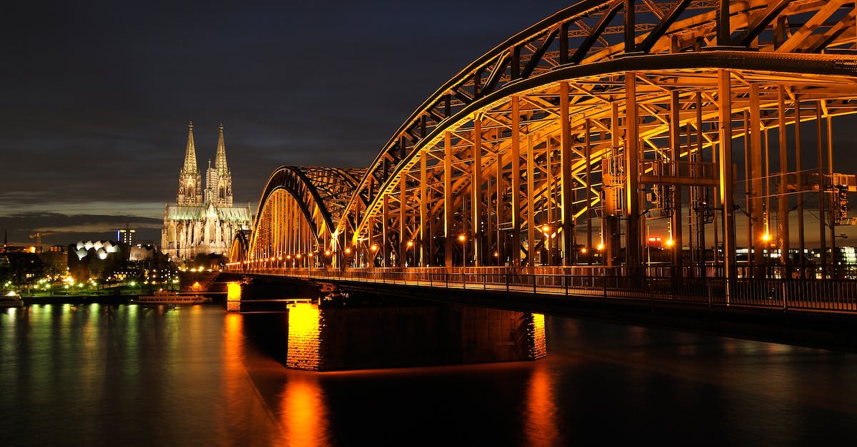 Approx how long will it take to go to Cologne Bonn Airport from Cologne city center? - Architectural Photo of Bridge during Nighttime