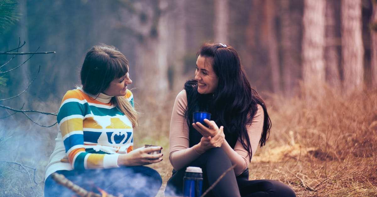 April Hokkaido Camping and Hiking [closed] - Two Women Sitting on Ground Near Bonfire