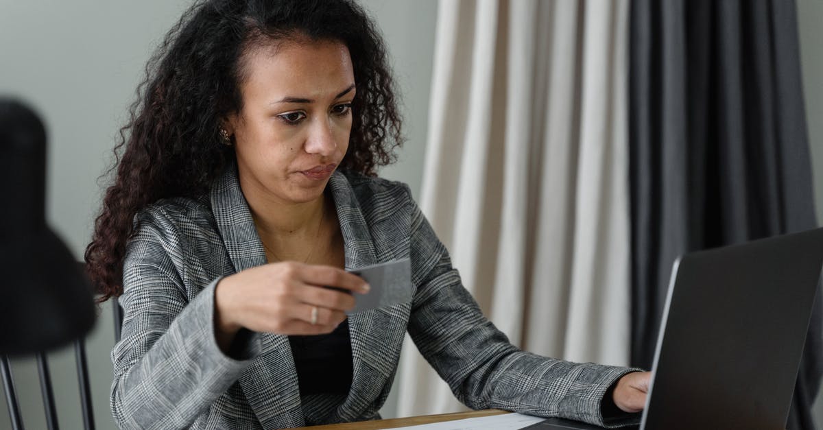 Are American Express credit cards widely accepted in Japan, specifically, Osaka? - Woman Holding a Card Using a Laptop