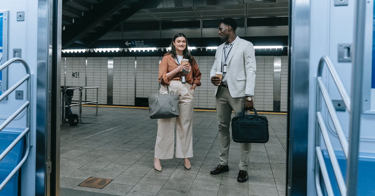 Are carry-on bags being weighed on long-haul flights? - A Man and Woman Standing while Having Conversation