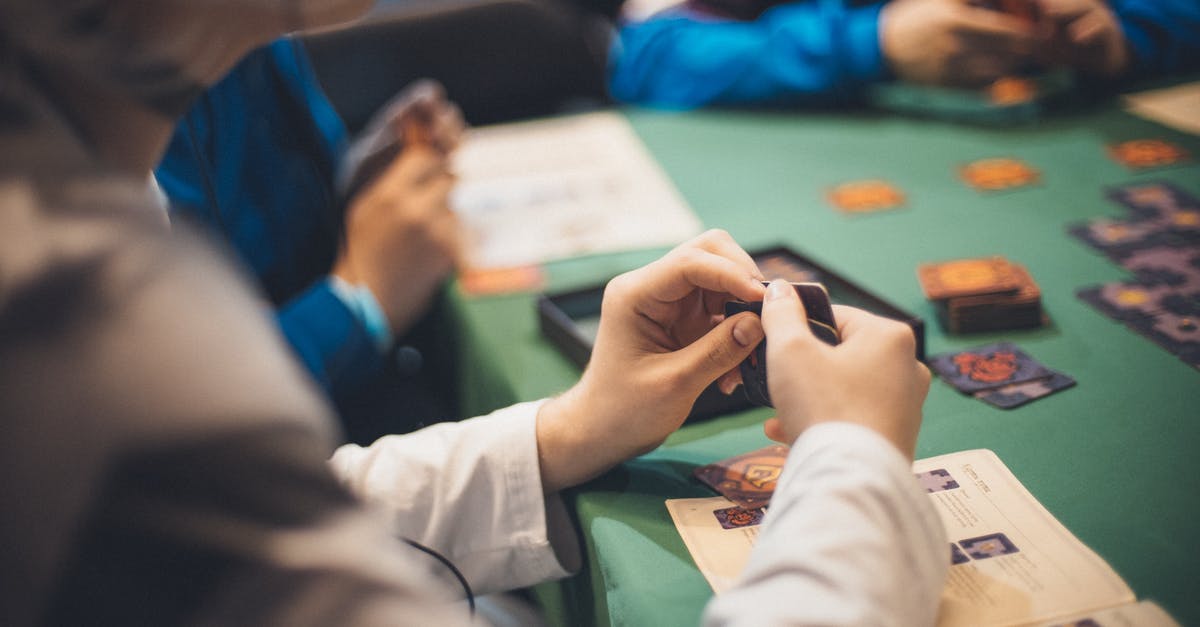 Are cheap "programmable" combination padlocks known to change their own combinations? - Crop people playing cards at table