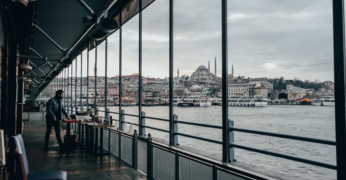 Are cruises' Shore Excursions worth the money? [closed] - Full body of male tourist standing near table on ship deck floating on rippling waterway in Istanbul