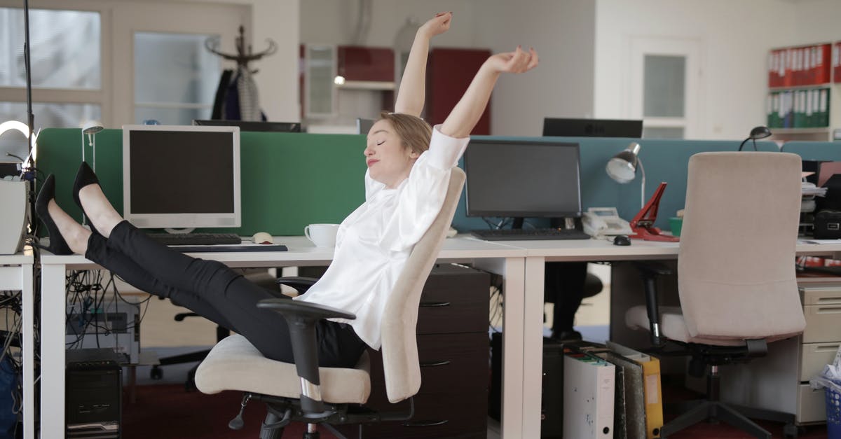 Are customs liable if they break something doing their job? - Side view of cheerful female employee in formal outfit sitting on office chair with crossed legs on desk and stretching while resting during work with closed eyes