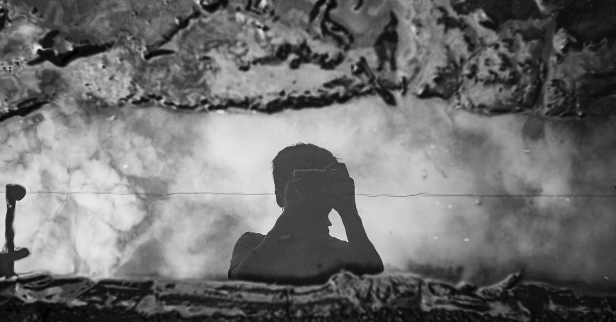 Are French hotels currently prohibited from using air conditioning? - Unrecognizable photographer taking photo of puddle on camera