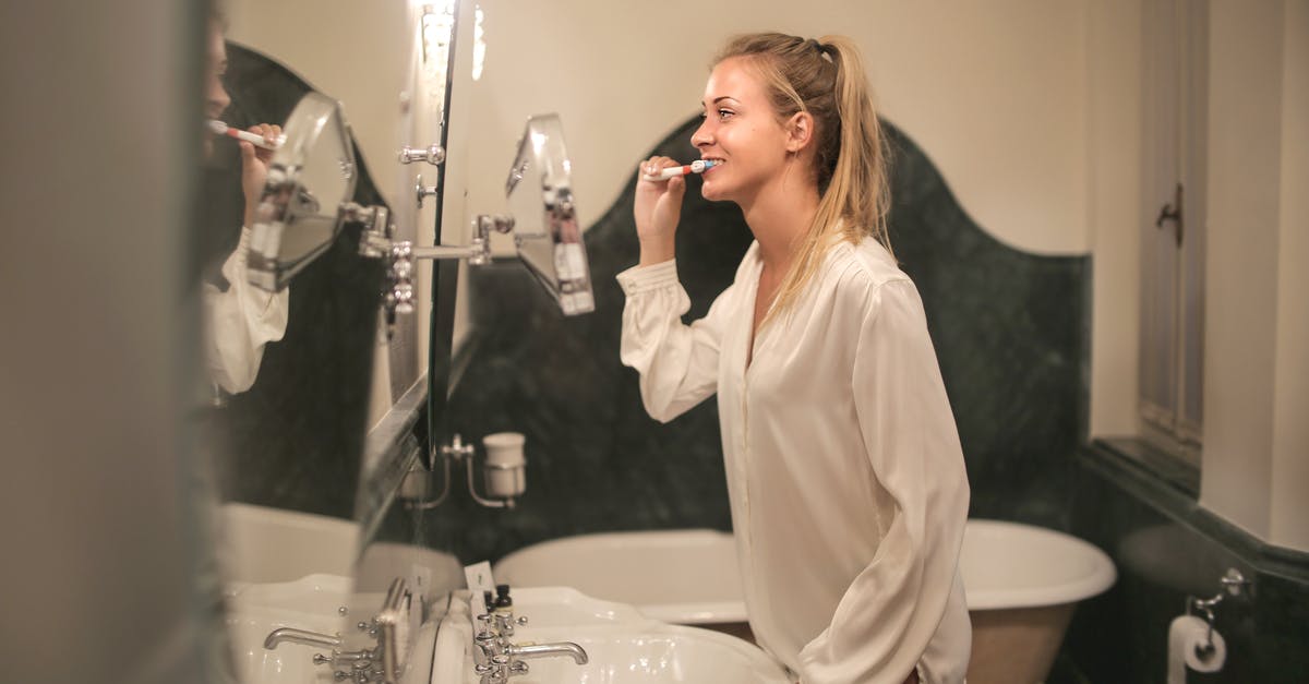 Are hotel "safes" really a joke to open? - Young woman cleaning teeth in bathroom