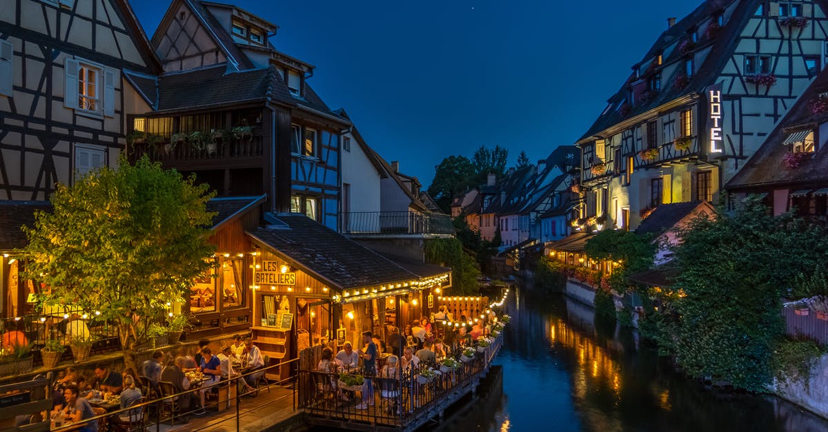 Are infants tolerated in restaurants in France and Italy? - Photography of Buildings and Canal during Nighttime