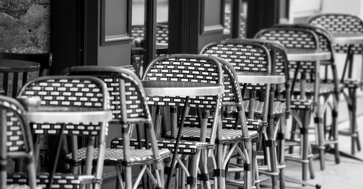 Are infants tolerated in restaurants in France and Italy? - Grayscale Photo of Chairs