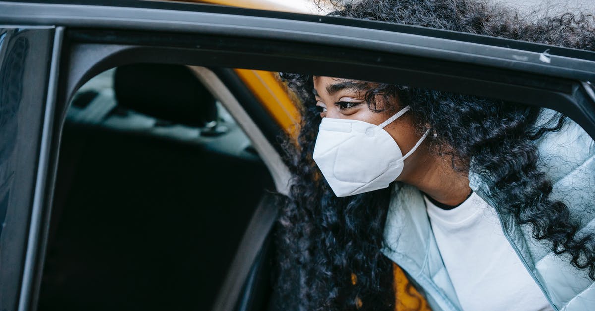 Are Istanbul Airport smoking lounges open during the COVID restrictions? - Black female in mask getting cab on city street