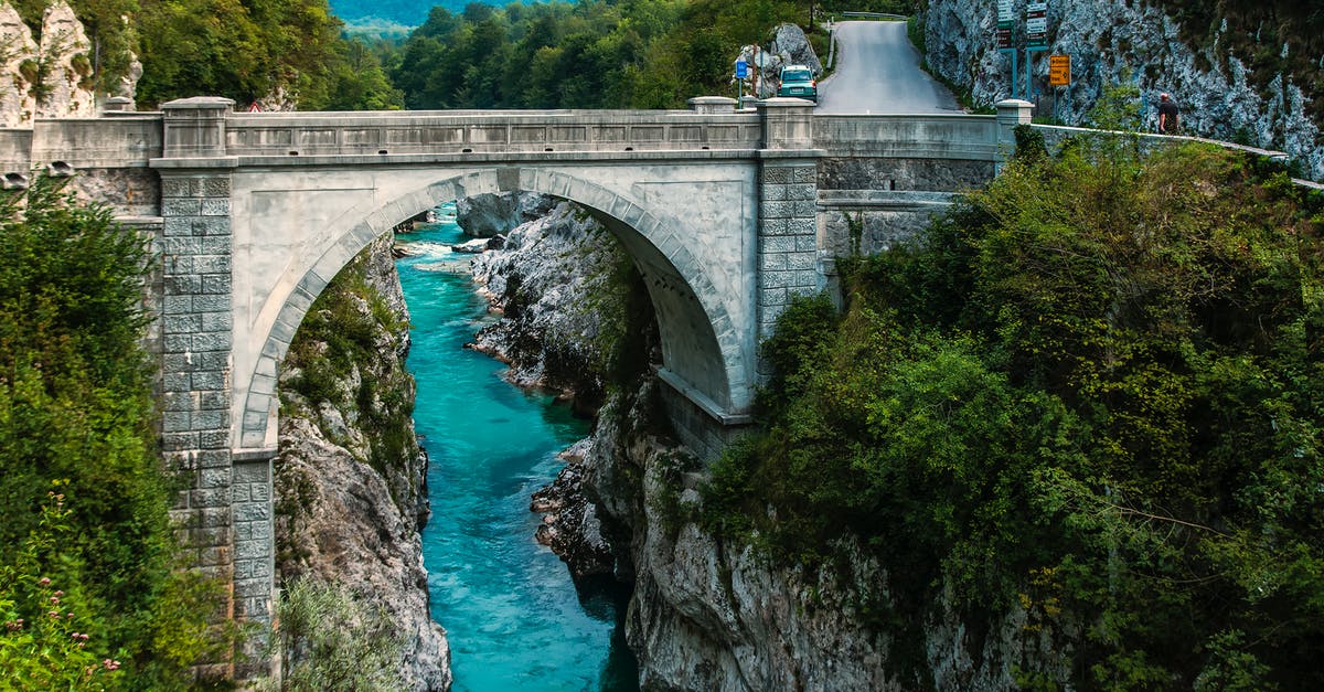 Are Jacob Hamblin Arch and Coyote Natural Bridge manageable in a one-day hike? - Concrete Bridge over Clear Blue River Beside Mountain